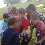 Alex showing the kids their pictures